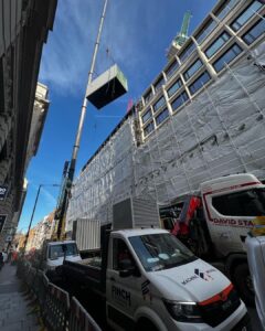 A containerized generator with attenuation and silencer lifted to a London roof