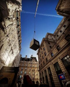 A containerized generator with attenuation and silencer lifted to a London roof