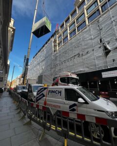 A containerized generator with attenuation and silencer lifted to a London roof